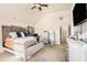 Comfortable main bedroom featuring a ceiling fan and carpeted flooring at 143 Massey Ln, Locust Grove, GA 30248