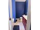 Bathroom with blue painted walls, tile floors, single vanity, toilet, and a shower/tub at 156 Brookridge Ct, Douglasville, GA 30134