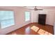 Bedroom featuring laminated wood floor, white walls, ceiling fan, and a dark armoire at 156 Brookridge Ct, Douglasville, GA 30134
