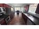 Modern kitchen features stainless steel appliances and dark wood flooring connecting to the naturally lit dining area at 156 Brookridge Ct, Douglasville, GA 30134
