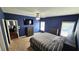 Main bedroom featuring a ceiling fan, carpet and navy blue walls with two windows at 156 Brookridge Ct, Douglasville, GA 30134