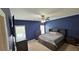 Main bedroom with a ceiling fan, carpet flooring, and navy blue walls at 156 Brookridge Ct, Douglasville, GA 30134
