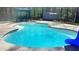 A backyard pool with a slide, gazebo, and trees at 156 Brookridge Ct, Douglasville, GA 30134