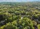 Expansive aerial view showing a home surrounded by dense trees and beautiful landscape at 1961 River Forest Rd, Atlanta, GA 30327