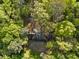 Aerial view of a home nestled among lush trees, providing privacy and a natural setting at 1961 River Forest Rd, Atlanta, GA 30327