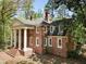 Brick home featuring white columns, dormer windows, and a well-manicured lawn at 1961 River Forest Rd, Atlanta, GA 30327