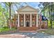 Stunning two-story brick home featuring grand columns, symmetrical design, and a stately entrance at 1961 River Forest Rd, Atlanta, GA 30327