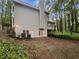 Exterior view of home back with walkout basement and lush greenery in a wooded area at 9174 Retreat Pass, Jonesboro, GA 30236