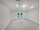 Unfinished basement with double doors leading outside to the lawn at 9174 Retreat Pass, Jonesboro, GA 30236