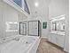 Bright bathroom featuring a large bathtub, walk in shower, and double vanity with lots of counter space at 9174 Retreat Pass, Jonesboro, GA 30236