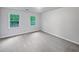 Empty bedroom with neutral carpet and two windows at 9174 Retreat Pass, Jonesboro, GA 30236