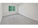 This bedroom has gray carpet and a window for natural light at 9174 Retreat Pass, Jonesboro, GA 30236