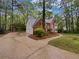 Brick home featuring a 3-car garage, mature trees and classic architectural details at 9174 Retreat Pass, Jonesboro, GA 30236