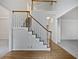 Bright foyer featuring hardwood floors, staircase with white spindles, and open floorplan at 9174 Retreat Pass, Jonesboro, GA 30236