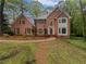 Charming two-story brick home with well-manicured lawn and mature trees at 9174 Retreat Pass, Jonesboro, GA 30236