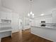 Bright, spacious kitchen with white cabinets, granite countertops, and stainless steel appliances at 9174 Retreat Pass, Jonesboro, GA 30236