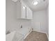 Utility or laundry room with a utility sink and ample cabinet space at 9174 Retreat Pass, Jonesboro, GA 30236