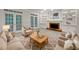 Bright living room with neutral tones, fireplace, and french doors allowing natural light to fill the space at 9174 Retreat Pass, Jonesboro, GA 30236