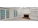 Bright living room with built-in shelving, fireplace, and french doors allowing natural light to fill the space at 9174 Retreat Pass, Jonesboro, GA 30236