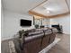 Spacious basement with a large leather sofa, TV, and desk with computer setup at 2099 Winsburg Nw Way, Kennesaw, GA 30144