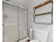 Bathroom featuring modern glass shower, toilet, and decorative shelving at 2099 Winsburg Nw Way, Kennesaw, GA 30144