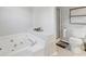Bathroom with a jacuzzi tub, shower, decorative accents, and functional layout at 2099 Winsburg Nw Way, Kennesaw, GA 30144