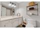 Bright bathroom featuring a large mirror, storage shelf, and white vanity at 2099 Winsburg Nw Way, Kennesaw, GA 30144