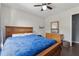 Bedroom with wooden furniture, ceiling fan, and a view of backyard trees at 2099 Winsburg Nw Way, Kennesaw, GA 30144