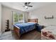 Cozy bedroom with natural light, a wooden bed frame, and hardwood floors at 2099 Winsburg Nw Way, Kennesaw, GA 30144