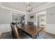 Elegant dining room with a tray ceiling, a modern chandelier, and a spacious layout at 2099 Winsburg Nw Way, Kennesaw, GA 30144