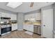 Efficient kitchen with stainless steel appliances, ample cabinet space and tile flooring at 2099 Winsburg Nw Way, Kennesaw, GA 30144