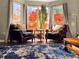 Comfortable sitting area with plush chairs, a small table, and natural light from bay window at 2099 Winsburg Nw Way, Kennesaw, GA 30144