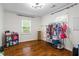 Bright bedroom with hardwood floors and natural light, showcasing ample closet space and modern decor at 2645 Sandstone Dr, Lawrenceville, GA 30043