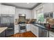 Bright kitchen features stainless steel appliances, granite countertops, and a stylish backsplash at 2645 Sandstone Dr, Lawrenceville, GA 30043