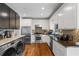 Modern kitchen with stainless steel appliances, granite counters, and wooden floors at 2645 Sandstone Dr, Lawrenceville, GA 30043