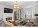 Inviting living room with a fireplace, a large tv, and ample natural light at 2645 Sandstone Dr, Lawrenceville, GA 30043