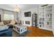 Bright living room features hardwood floors, fireplace, TV and built-in bookshelves at 2645 Sandstone Dr, Lawrenceville, GA 30043