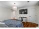 Comfortable main bedroom features hardwood floors, TV and a view to the en-suite bathroom at 2645 Sandstone Dr, Lawrenceville, GA 30043