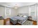 Comfortable main bedroom features hardwood floors, natural light and neutral décor at 2645 Sandstone Dr, Lawrenceville, GA 30043