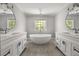 Bathroom showcasing dual vanities, a soaking tub and lots of natural light at 3705 Paces Park Se Cir, Smyrna, GA 30080