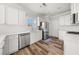 Bright kitchen featuring white cabinets, stainless steel appliances, and wood-look flooring at 3705 Paces Park Se Cir, Smyrna, GA 30080