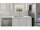 Bright kitchen featuring white cabinets, stainless steel appliances and sink under window at 3705 Paces Park Se Cir, Smyrna, GA 30080