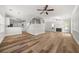 Open-concept living area with hardwood floors, a fireplace, and seamless flow to the kitchen at 3705 Paces Park Se Cir, Smyrna, GA 30080