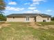 The back of a one-story house with an AC unit, a level yard, and a set of double doors at 41 Olde Town Way, Rockmart, GA 30153