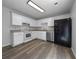 Well-lit kitchen with white cabinets and stainless steel appliances at 41 Olde Town Way, Rockmart, GA 30153