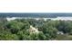 Expansive aerial view of a serene neighborhood surrounded by lush greenery and a picturesque lake in the background at 4424 Robinson St, Acworth, GA 30101