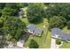 Aerial view of charming home with mature trees, a well-manicured lawn, and a detached garage at 4424 Robinson St, Acworth, GA 30101
