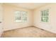 Bright, carpeted bedroom with two windows providing ample natural light at 4424 Robinson St, Acworth, GA 30101