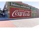 Historic Coca-Cola mural on a brick building, adding vintage charm to the streetscape at 4424 Robinson St, Acworth, GA 30101