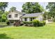Well-kept home with a lush green lawn and mature trees, complemented by a storage shed in the backyard at 4424 Robinson St, Acworth, GA 30101
